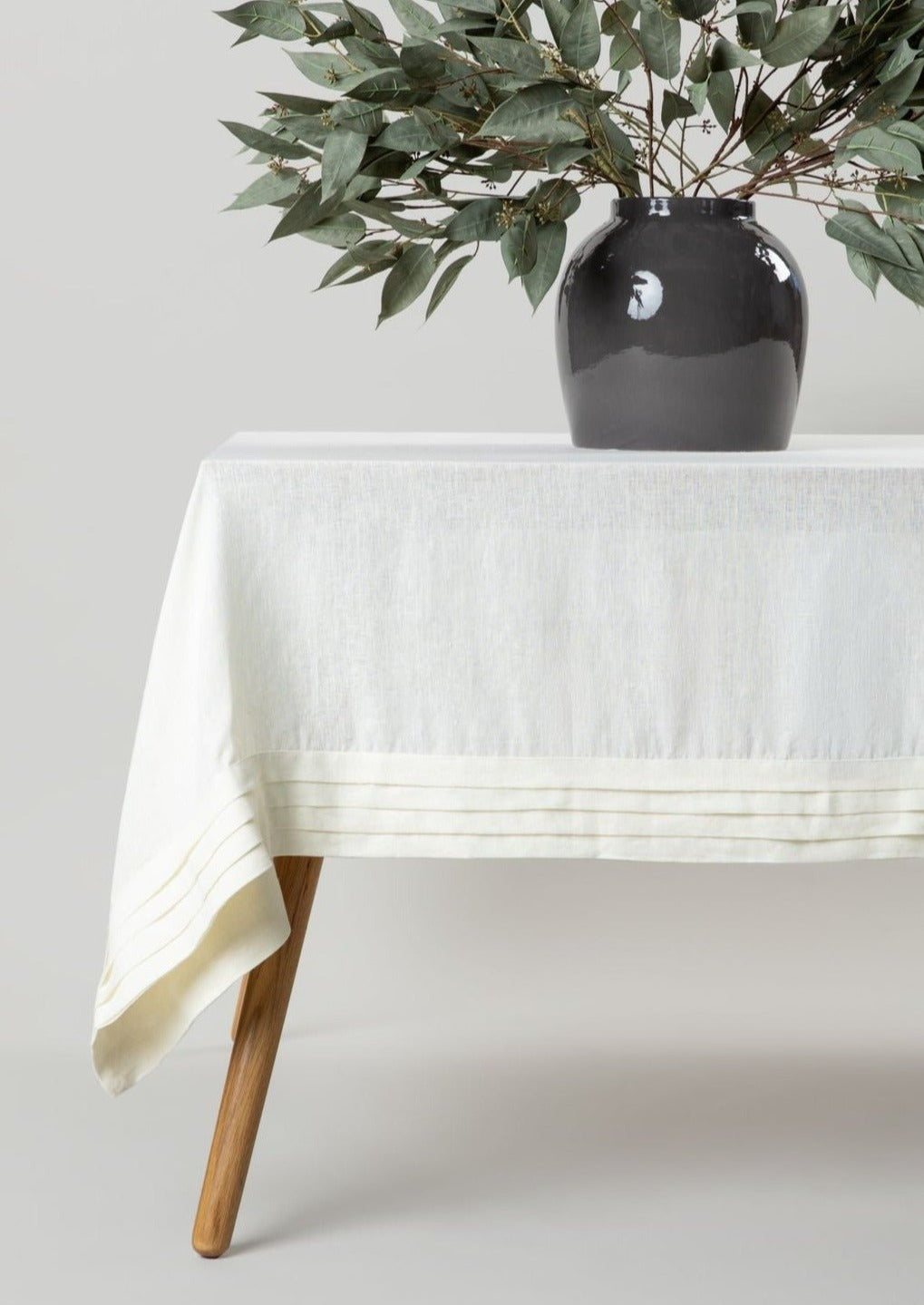 Malaika Linen Pleated Tablecloth with Artificial Eucalyptus Arrangement